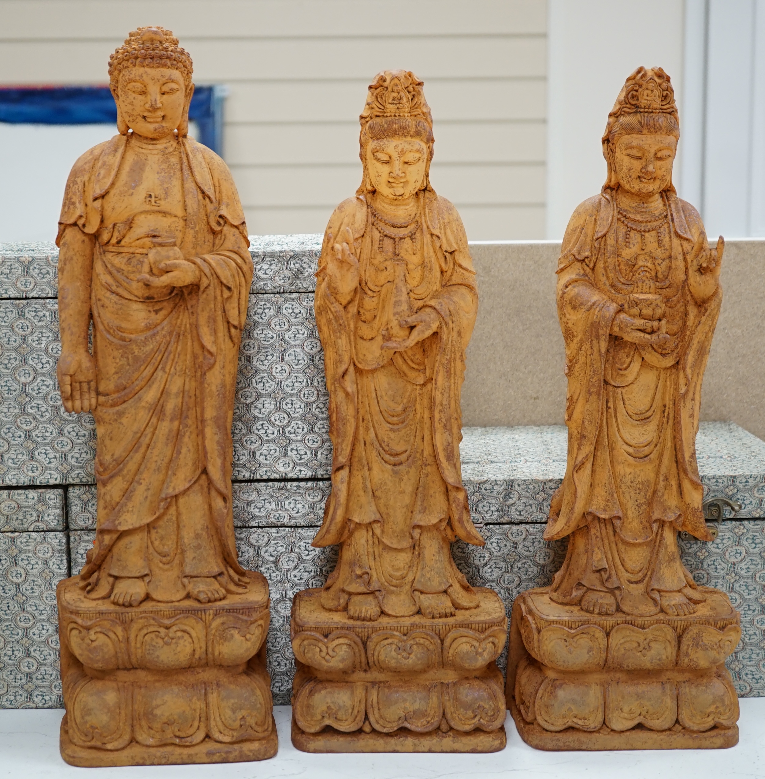 A set of three large Chinese patinated heavy glass figures of Bodhisattvas, tallest 49cm. Condition - good